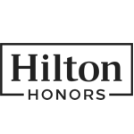 The image is the logo for Hilton Honors, featuring the words "Hilton Honors" inside a rectangular border, in a simple black font. logo on footer section. Link to external website.