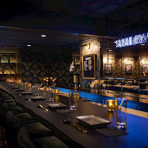 A dimly lit sushi restaurant with bar seating, adorned with neon 