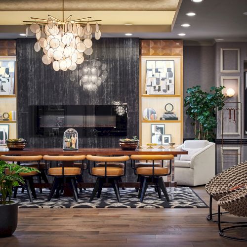 Cozy cafe interior with warm lighting, plants, wooden tables, and a small counter; a chalkboard menu and a few people seated, relaxing.